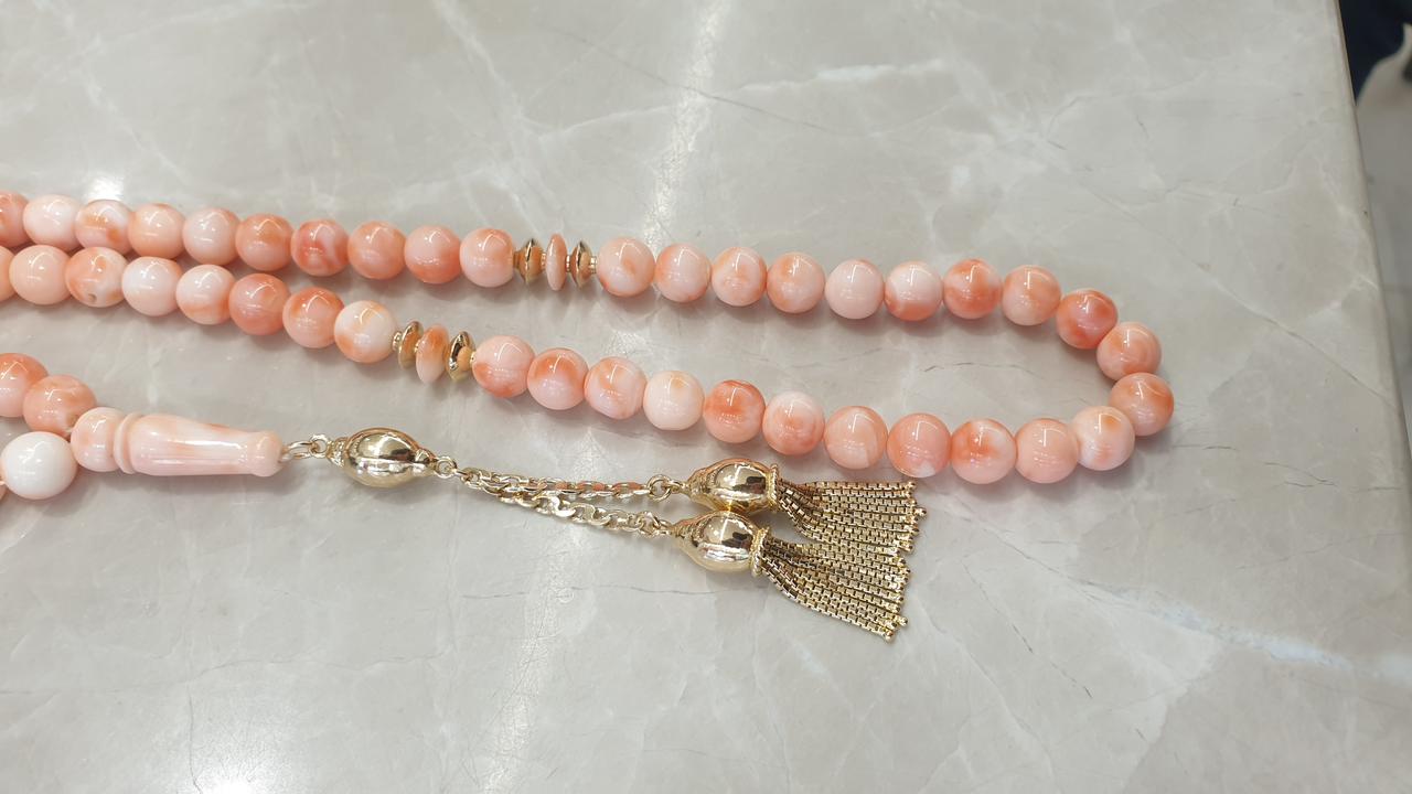 Pink worry beads with a gold tassel