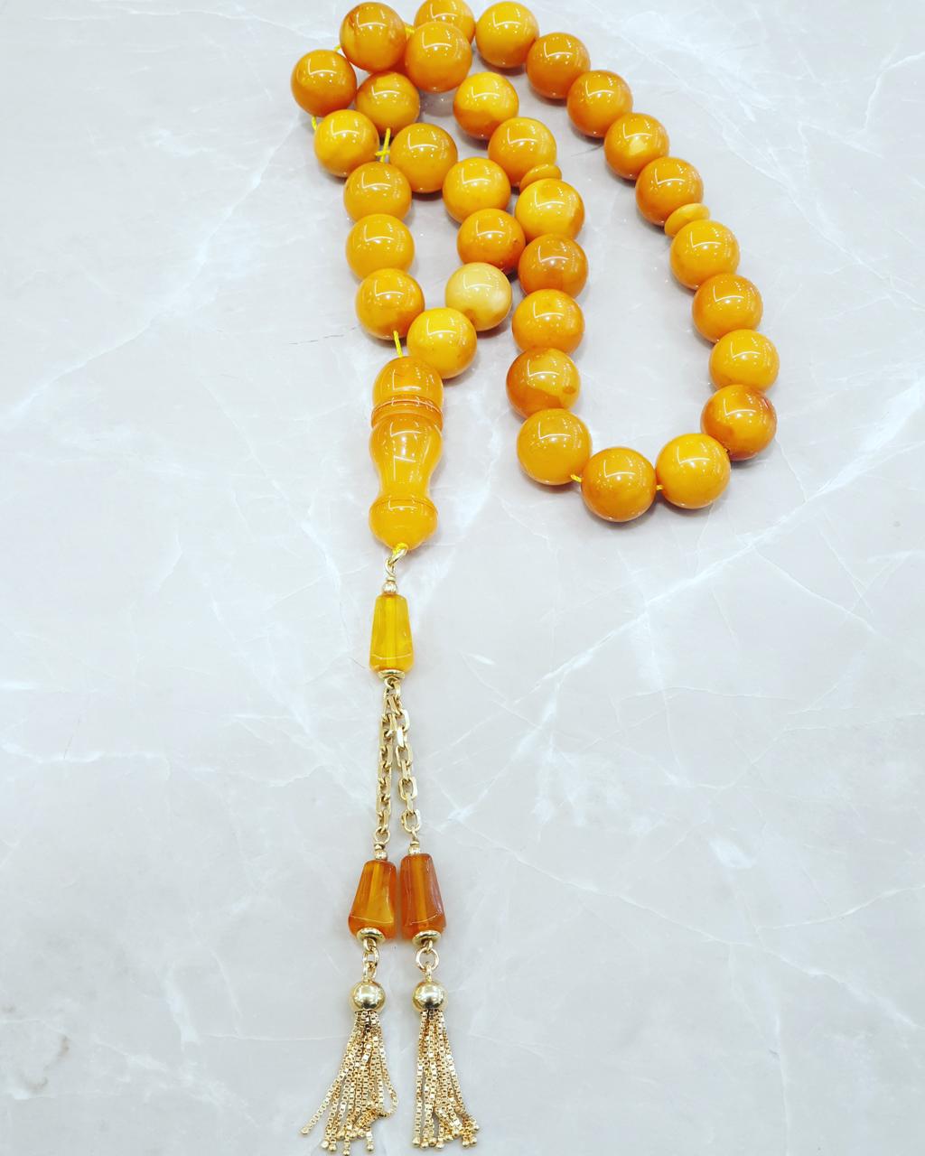 Yellow amber worry beads with a gold tassel